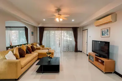 a living room with a couch and a television at Rawai Palm Beach Квартира 220м in Rawai Beach