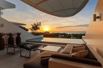 a living room with a couch and a view of the ocean at Kata Rocks in Kata Beach