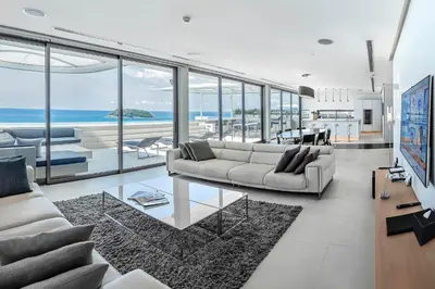 a living room with a couch and a table at Kata Rocks in Kata Beach