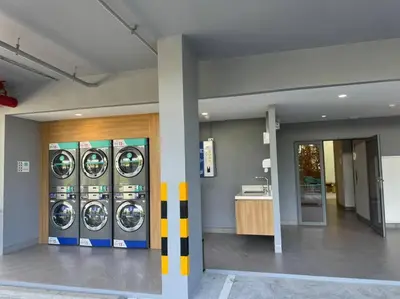 a room with four washing machines in a building at New apartment 2bedrooms in Laguna lakeside Bang Tao beach in Phuket