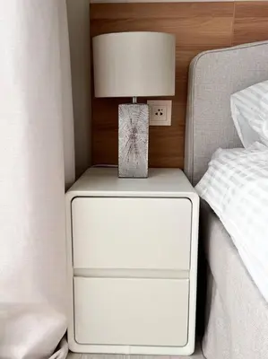 a nightstand with a lamp on it next to a bed at New apartment 2bedrooms in Laguna lakeside Bang Tao beach in Phuket