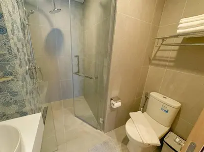 a bathroom with a shower and a toilet and a sink at New apartment 2bedrooms in Laguna lakeside Bang Tao beach in Phuket