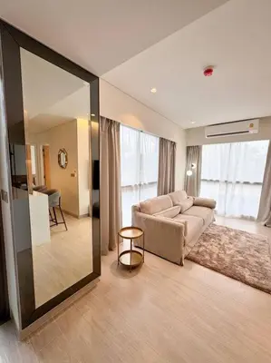 a living room with a couch and a large mirror at New apartment 2bedrooms in Laguna lakeside Bang Tao beach in Phuket