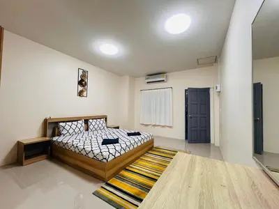 a bedroom with a bed and a rug at Vista Residence Patong in Patong Beach