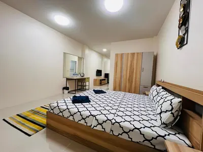 a bedroom with a large bed in a room at Vista Residence Patong in Patong Beach