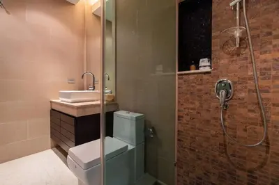 a bathroom with a shower and a toilet and a sink at Sea view Villa on Rawai beach in Ban Saiyuan (1)