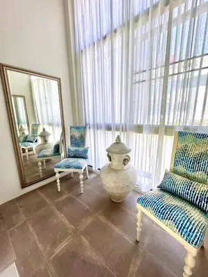 a living room with a large mirror and a vase and chairs at Sea view Villa on Rawai beach in Ban Saiyuan (1)