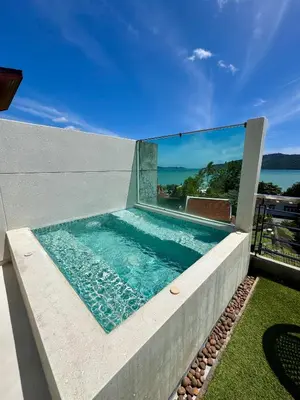 a swimming pool on the side of a house at Sea view Villa on Rawai beach in Ban Saiyuan (1)