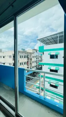 a view of a building from a window at Lucky One Guesthouse in Patong Beach