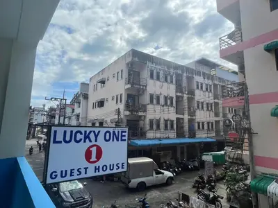a sign that reads lucky one guest house in front of a building at Lucky One Guesthouse in Patong Beach