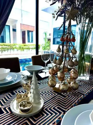 a table with christmas ornaments on top of it at Funtime pool villa in Kata Beach