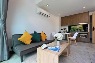a living room with a couch and a table at Duplex Condo pool access in Rawai Beach