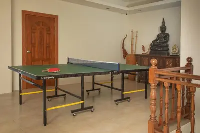 a ping pong table in the middle of a room at Villa on Panwa with 2 house keepers in Ban Bo Rae
