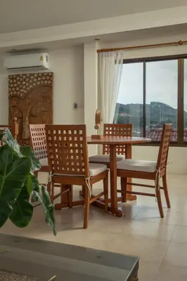 a dining room with a table and chairs and a window at Villa on Panwa with 2 house keepers in Ban Bo Rae