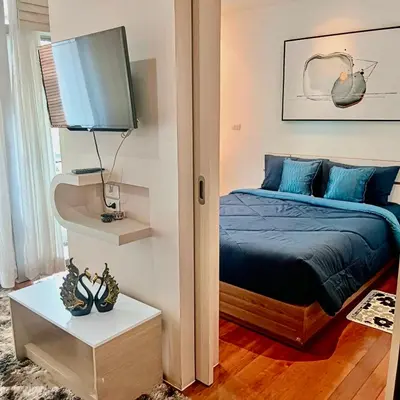 a bedroom with a bed and a flat screen tv at DREAMS APARTMENTS by ART PATONG RESIDENCE in Patong Beach