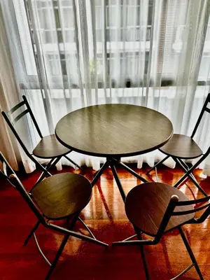 a table and two chairs next to a window at DREAMS APARTMENTS by ART PATONG RESIDENCE in Patong Beach
