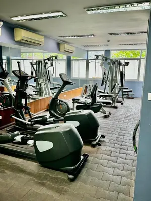 a gym with rows of exercise bikes and treadmills at DREAMS APARTMENTS by ART PATONG RESIDENCE in Patong Beach