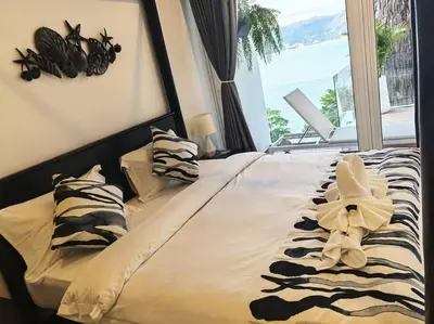a bed with a flower on it with a window at little princess \u5c0f\u516c\u4e3b\u522b\u5885 in Patong Beach
