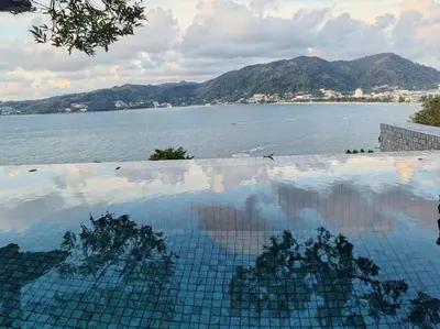 a swimming pool with a view of a body of water at little princess \u5c0f\u516c\u4e3b\u522b\u5885 in Patong Beach