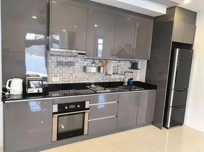 a kitchen with stainless steel appliances and a refrigerator at little princess \u5c0f\u516c\u4e3b\u522b\u5885 in Patong Beach