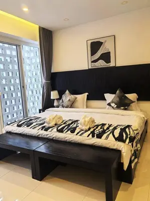 a bedroom with a large bed with two towels on it at little princess \u5c0f\u516c\u4e3b\u522b\u5885 in Patong Beach