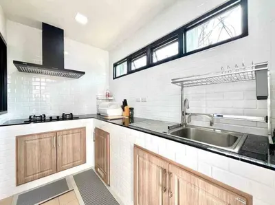a kitchen with a sink and a counter top at Mali Villa in Ban Suan