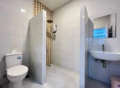 a bathroom with a toilet and a sink at Mali Villa in Ban Suan