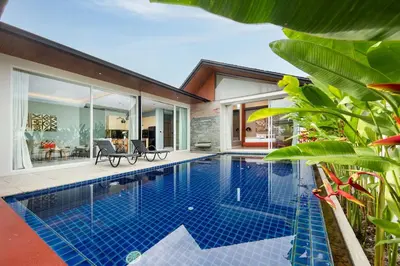 a swimming pool in the backyard of a house at Solano Tropical 3BR Pool Villa at Bang Tao in Layan Beach