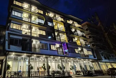 a large building with lit up windows at night at Diva Boutique Hotel in Patong Beach