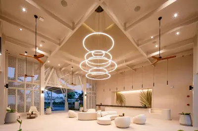 a large lobby with white furniture and a large chandelier at Lalynn Resort & Villas, Phuket in Thalang