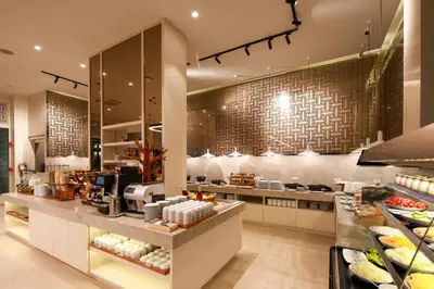 a restaurant with a counter with food on it at Lalynn Resort & Villas, Phuket in Thalang
