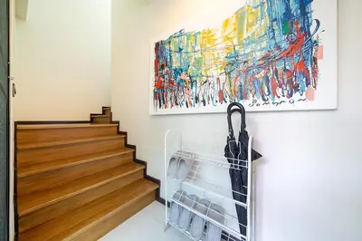 a hallway with a painting and an umbrella on the wall at The fin villa rawai 2 bedroom in Ban Saiyuan (1)