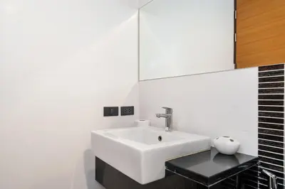 a bathroom with a white sink and a mirror at The fin villa rawai 2 bedroom in Ban Saiyuan (1)