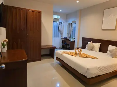 a bedroom with a bed with two towels on it at NJoy Boutique Guesthouse in Patong Beach