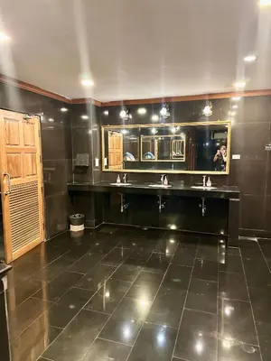 a large kitchen with black walls and a tile floor at Chang Hostel Patong Phuket in Patong Beach