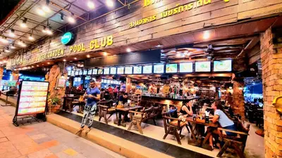 a group of people sitting at tables in a restaurant at Chang Hostel Patong Phuket in Patong Beach