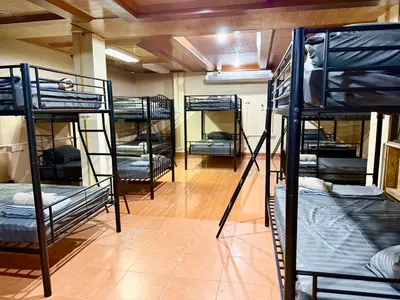 a room filled with lots of bunk beds at Chang Hostel Patong Phuket in Patong Beach