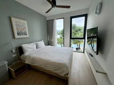 a bedroom with a bed and a large window at 2bedrooms Cassia Residence lake view in Phuket