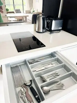 an open drawer in a kitchen with silver utensils at 2bedrooms Cassia Residence lake view in Phuket