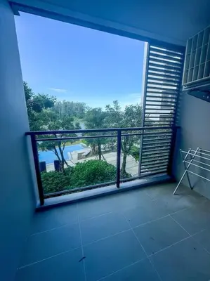 a room with a large window with a view of a pool at 2bedrooms Cassia Residence lake view in Phuket