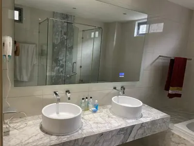 a bathroom with two sinks and a large mirror at Kata Beach TheView luxurious Condonomium in Kata Beach