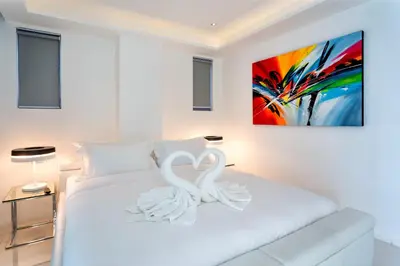 two white swans sitting on top of a white bed at Kata Beach TheView luxurious Condonomium in Kata Beach