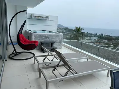 a balcony with a hammock chair and a fireplace at Kata Beach TheView luxurious Condonomium in Kata Beach