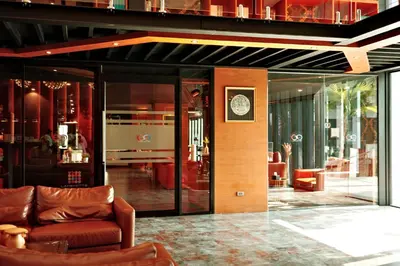 a living room with a couch and a clock on a wall at City Gate Kamala N103 by Phuket Sabay Rent in Kamala Beach