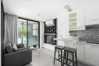 a kitchen and living room with a couch and a table at City Gate Kamala N103 by Phuket Sabay Rent in Kamala Beach