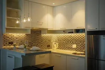 a kitchen with white cabinets and a sink at City Gate Kamala N103 by Phuket Sabay Rent in Kamala Beach