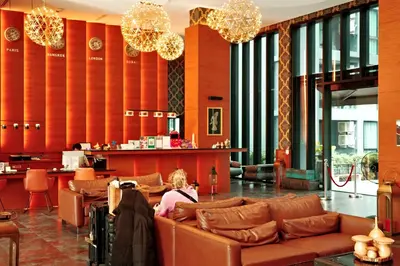 a woman sitting on a couch in a lobby at City Gate Kamala N103 by Phuket Sabay Rent in Kamala Beach