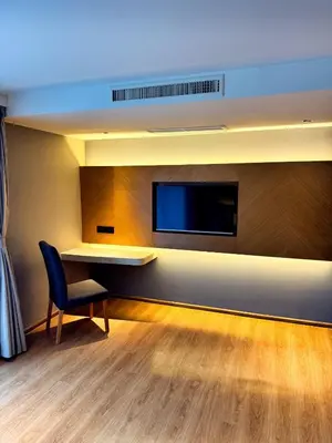 a room with a desk and a tv on a wall at New stylish studio in La Vita 5 in Rawai Beach