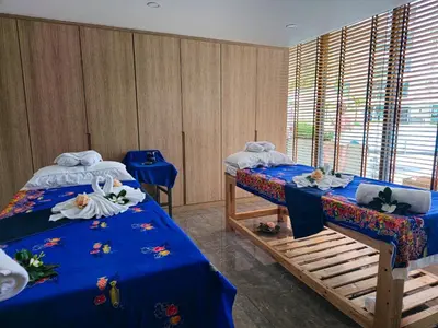 two beds in a room with blue sheets and towels at New stylish studio in La Vita 5 in Rawai Beach