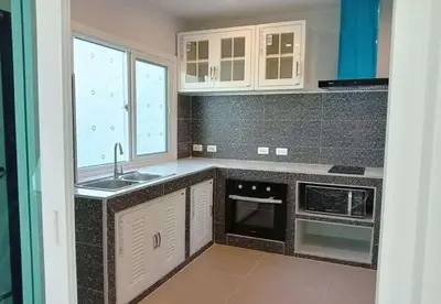 a kitchen with a sink and a stove at Cozy House by Cody One in Thalang